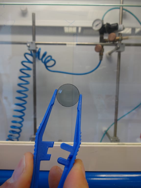 This disc has been coated with a thin film of a light-absorbing polymer solution, which could be printed on flexible surfaces. Such polymer-based solar cells could be mass-produced in a process similar to printing newspapers.