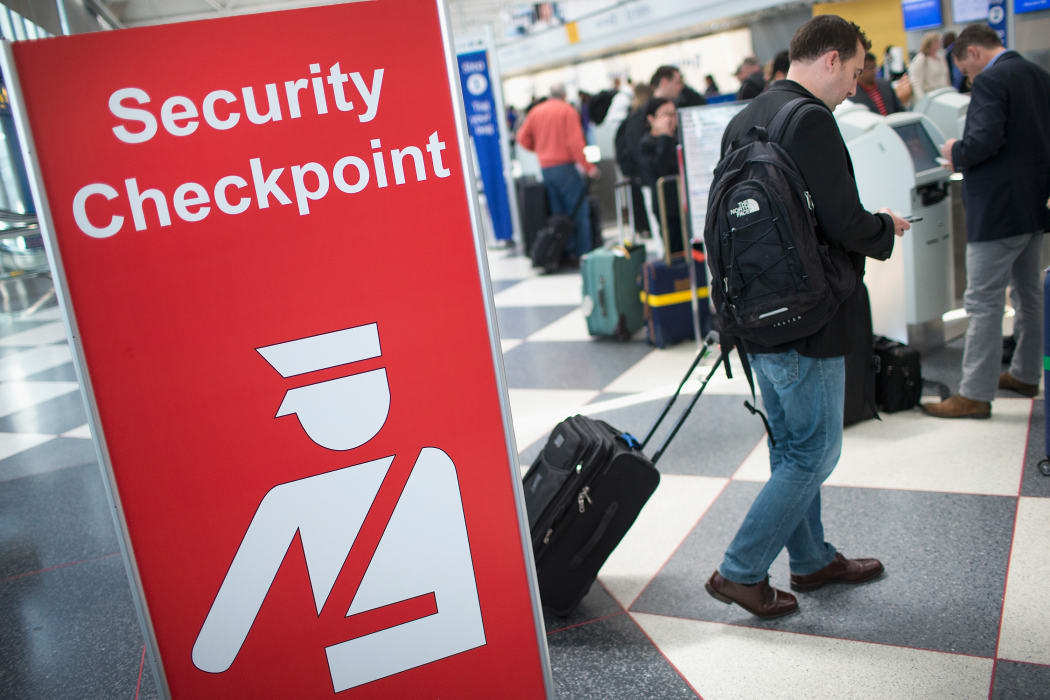 A sign directs travellers to a security checkpoint staffed by Transportation Security Administration (TSA) workers at O'Hare Airport in Chicago, Illinois in June 2015.