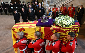 Pallbearers from The Queen's Company, 1st Battalion Grenadier Guards carry the coffin of Queen Elizabeth II past Camilla, Queen Consort, Catherine, Princess of Wales, Sophie, Countess of Wessex, Meghan, Duchess of Sussex, Prince Edward, Duke of Kent and Prince Richard, Duke of Gloucester, as they arrive at Westminster Hall at the Palace of Westminster in London on 14 September, 2022, where the coffin will to Lie in State.
