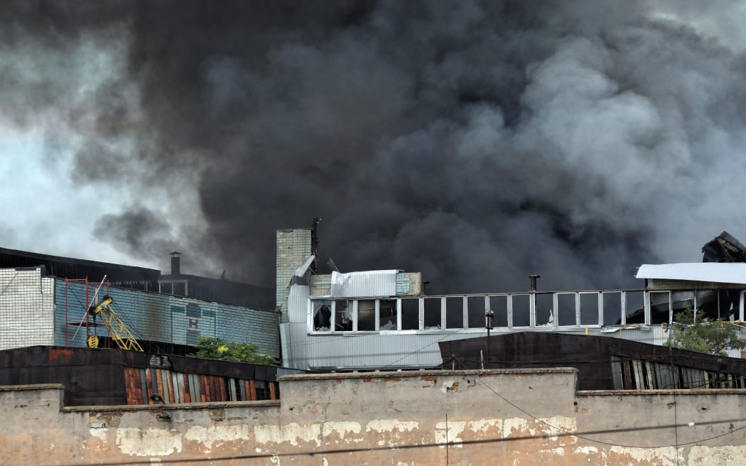 ODESA, UKRAINE - JULY 16, 2022 -  A plume of smoke rises above a commercial and industrial warehouse hit by a Russian rocket, Odesa, southern Ukraine. This photo cannot be distributed in the Russian Federation. NO USE RUSSIA. NO USE BELARUS. (Photo by Nina Liashonok / NurPhoto via AFP)