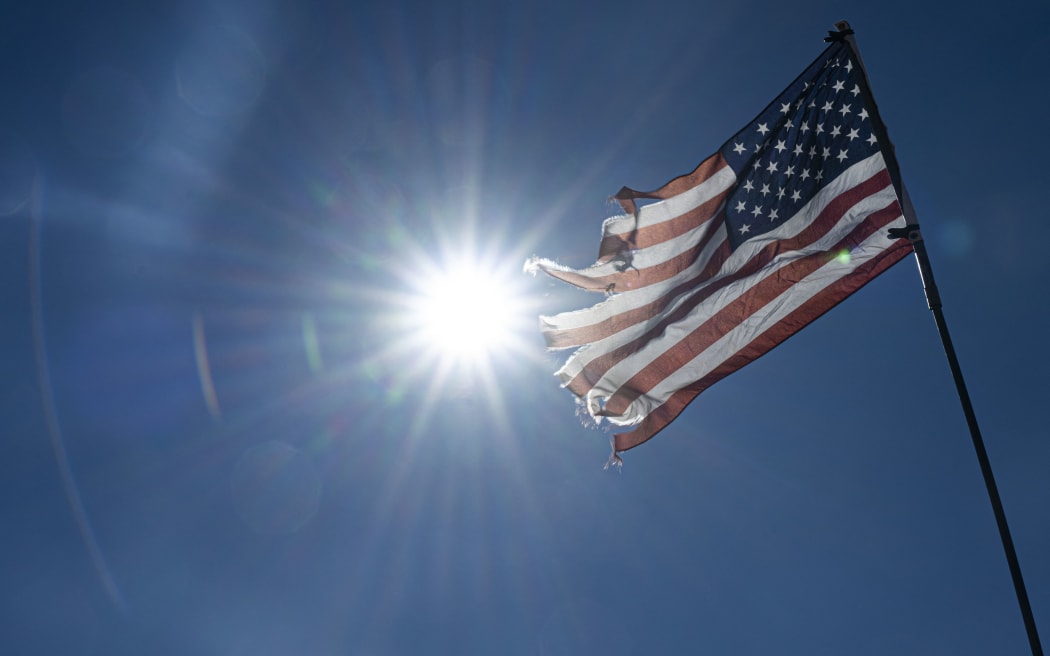 A tattered flag of the United States is seen during the the event "Ride to the Polls" in Kayenta, Arizona, on November 05, 2024. This ride is the third Election Day Trail Ride, open to the public and all about showing the resilience, power, and influence of the Indigenous community while remembering their ancestors who rode the same trails.