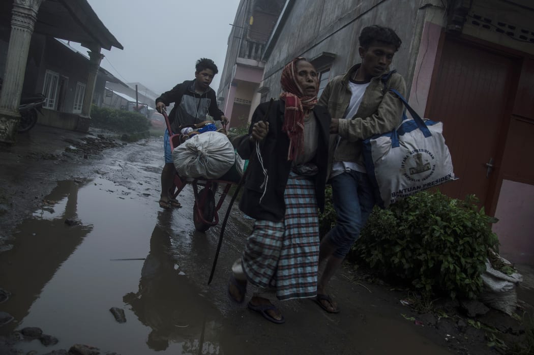 Villagers leave their homes to a safer area as local government evacuate people who live close to Mount Sinabung.
