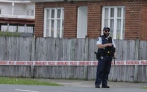 A police officer guards the scene of a homicide in Naenae, Lower Hutt, on 10 December 2024.