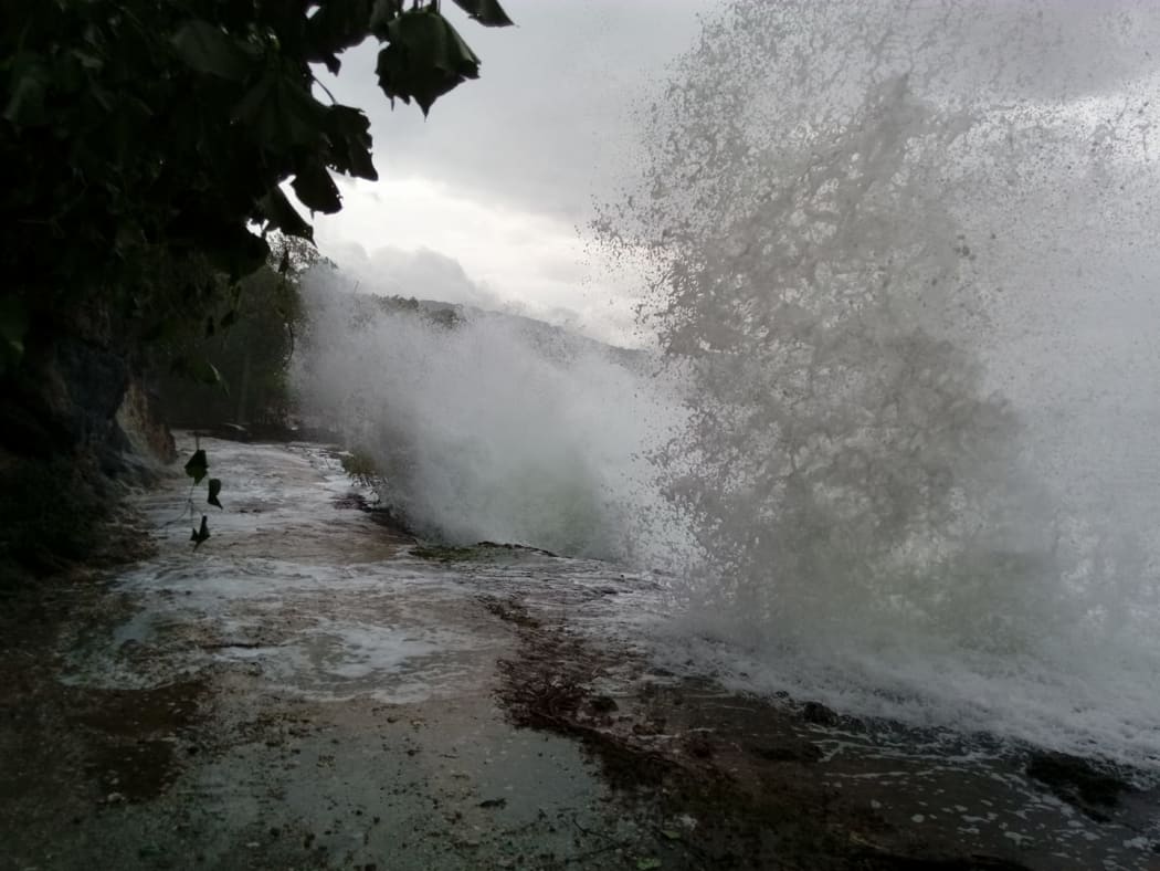 Heavy seas hit a road on Pentecost during Cyclone Hola.
