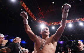 Oleksandr Usyk celebrates victory in his IBF, IBO, WBC and WBO World Heavyweight titles' fight.