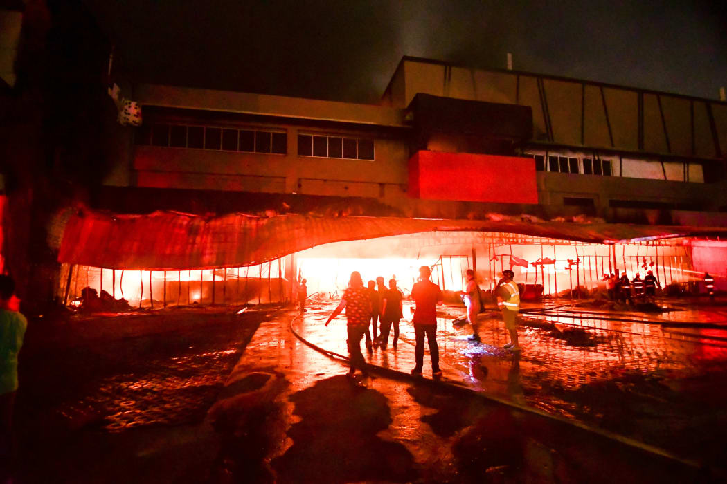 Firemen try to put out a fire inside a mall following a 6.4-magnitude quake in General Santos City, in southern island of Mindanao.