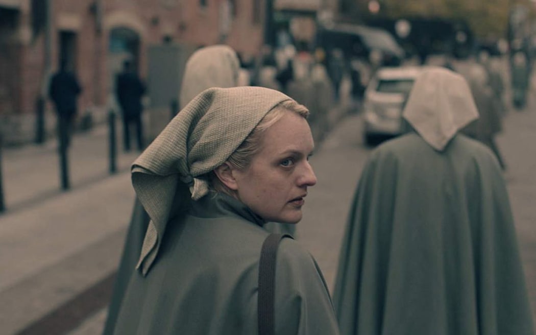 Elisabeth Moss in the third season of The Handmaid's Tale, after burying a body in the backyard.