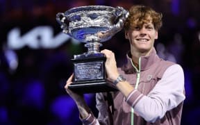 Italy's Jannik Sinner celebrates with the Norman Brookes Challenge Cup trophy after defeating Russia's Daniil Medvedev in the men's singles final match on day 15 of the Australian Open tennis tournament in Melbourne on January 28, 2024. (Photo by Martin KEEP / AFP) / -- IMAGE RESTRICTED TO EDITORIAL USE - STRICTLY NO COMMERCIAL USE --