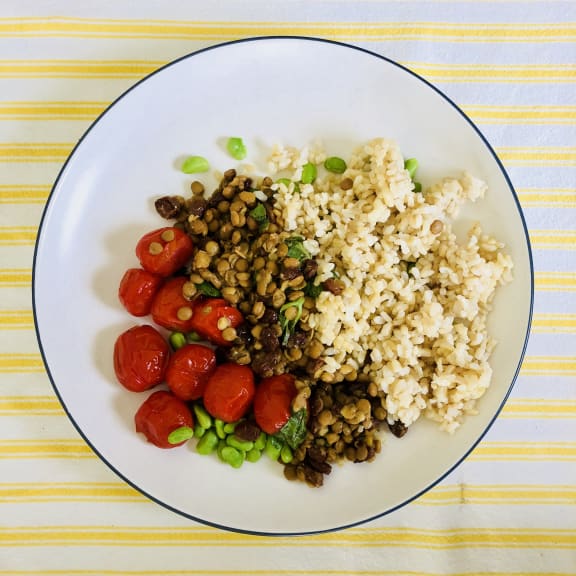 Lentil, tomato and sultana salad served here with brown rice and shelled edamame.