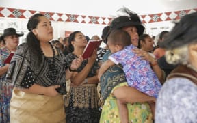 People attend church in NUku'alofa, the first Sunday after Cyclone Gita struck