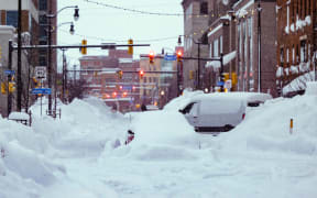 Vehicles trapped under heavy snow in the streets of downtown Buffalo, New York state, 26/12/22