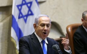 Israel's Prime Minister Benjamin Netanyahu addresses lawmakers during a special session to vote on a new government at the Knesset in Jerusalem, on 13 June 2021.