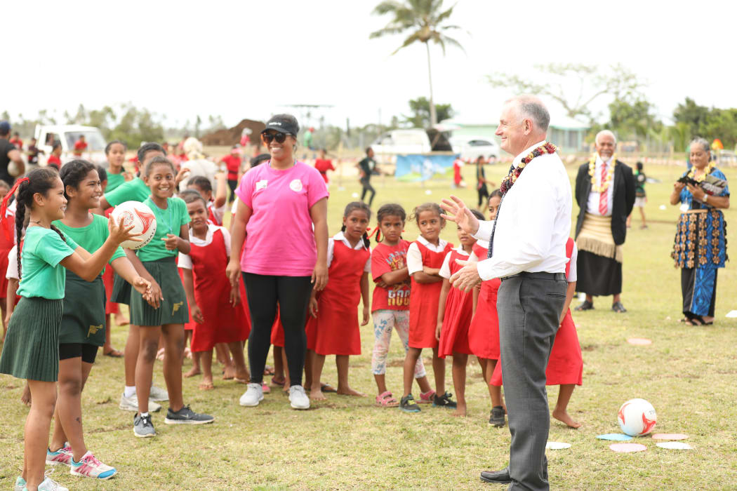 Speaker Trevor Mallard's netball skills are put to the test by students at Vaini Government Primary School where a New Zealand assisted sports programme is in place