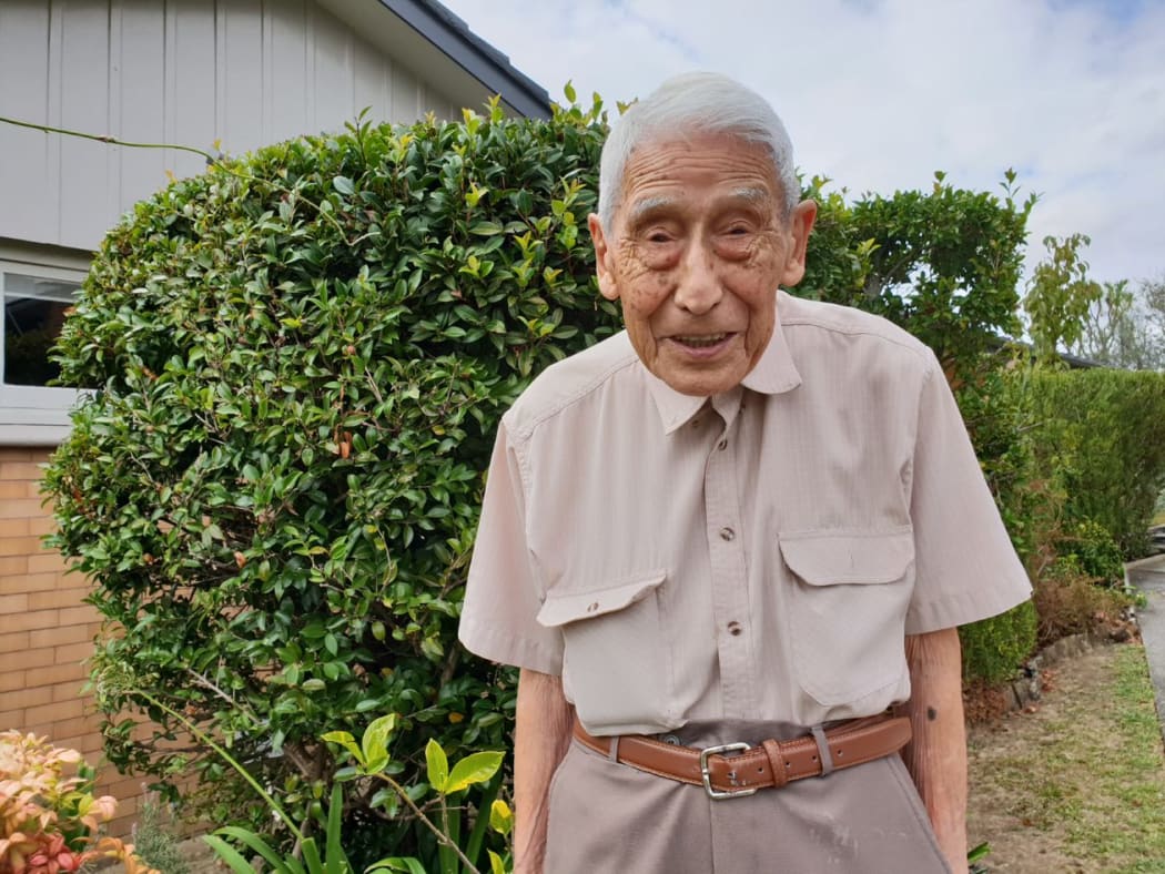 John Sato in his garden at home