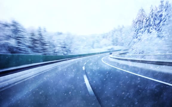 Dangerous blurred highway winter driving. Winter snowy conditions on the highway. Motion blur visualizies the speed and dynamics.