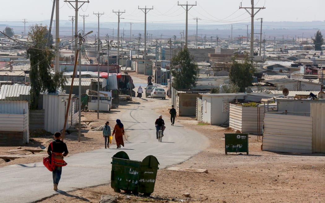 People walk down a street at the Zaatari camp for Syrian refugees, near the Jordanian city of Mafraq, about 80Km north of the capital Amman on January 13, 2025. Syrians living in the Zaatari camp in Jordan, the largest Syrian refugee camp in the world, are hesitant to return to their country about a month and a half after the fall of 
Bashar al-Assad’s rule, due to the stability they found there throughout the years of conflict. (Photo by Khalil MAZRAAWI / AFP)