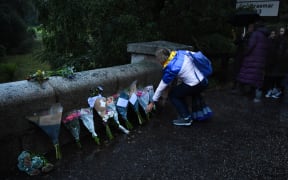 Members of the public leave floral tributes on the roadside outside the Balmoral Estate in Ballater, Scotland on September 9, 2022.