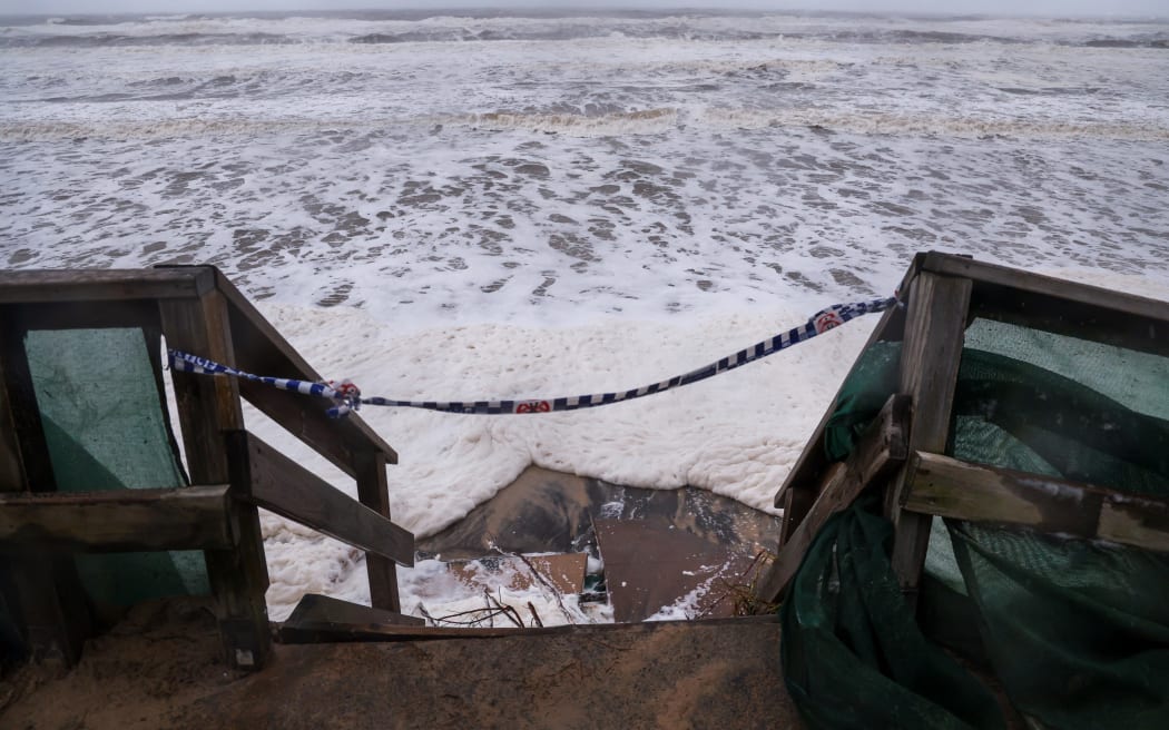 Waves break onto a stairway along the footpath along Main Beach located on the Gold Coast on 8 March.