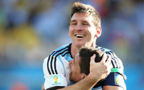 Argentina's Lionel Messi embraces Angel di Maria after his match-winning goal against Switzerland.