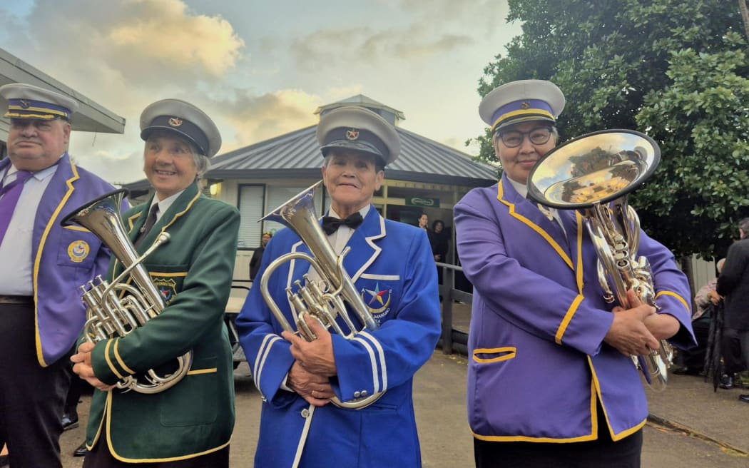 Te Haahi Ratana Brass Band led their tumuaki and morehu onto the marae this morning: (from left) Margaret Wairuku Radovanovich, Peara Pou and Beverley Webster. At the gates of Tuurangawaewae, on the morning of the third day of the tangi for Kiingi Tuheitia, 1 September, 2024.