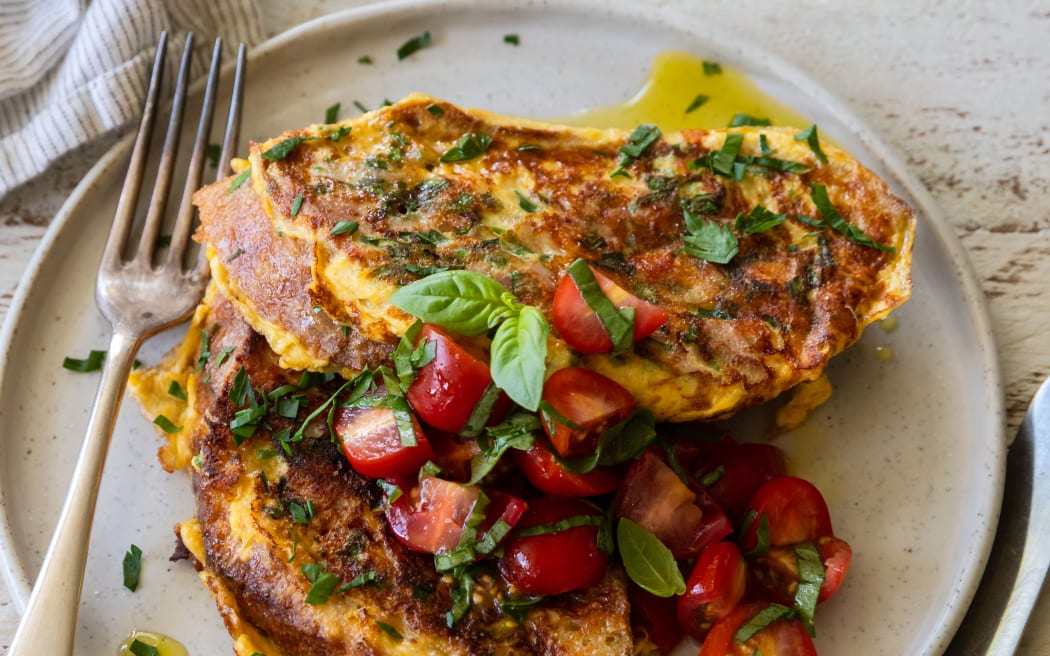 A plate of Savoury French toast with ham and wholegrain mustard, garnished with tomato salad.