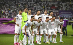 Iran's players pose for a team photo before their match against the USA in Group B of the 2022 World Cup in Doha. (Photo by Amin / Middle East Images via AFP)