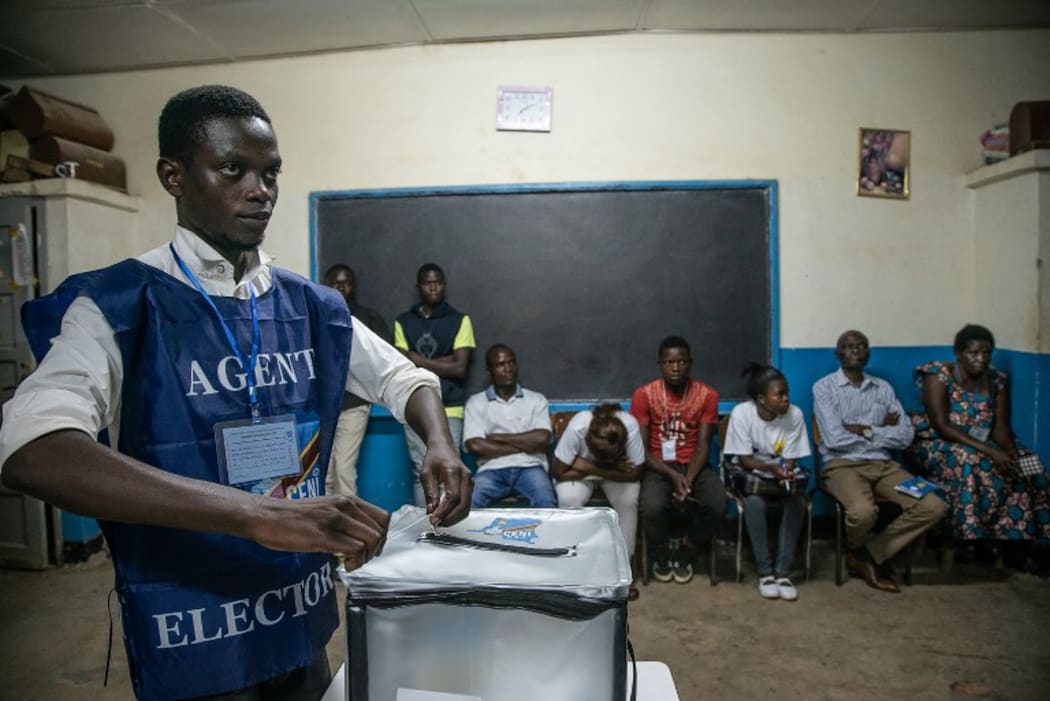 An Independent National Electoral Commission (CENI) agent seals a ballot box in front of observers at the Kitendo voting centre in Lubumbashi's Mapala district on December 30, 2018, following the close of polls in the country's presidential, provincial and national elections.  AFP
