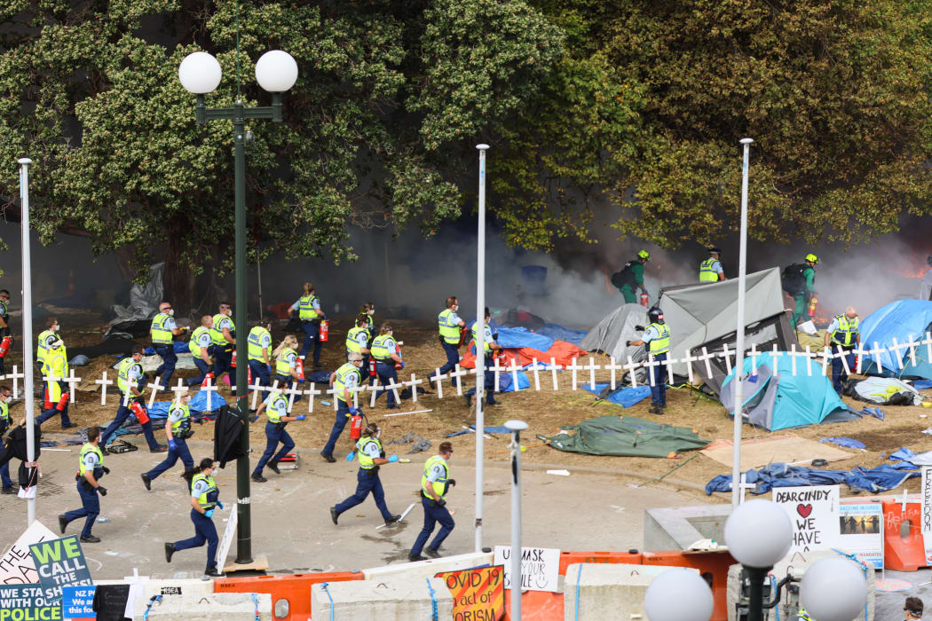 A group of police dash in with fire extinguishers