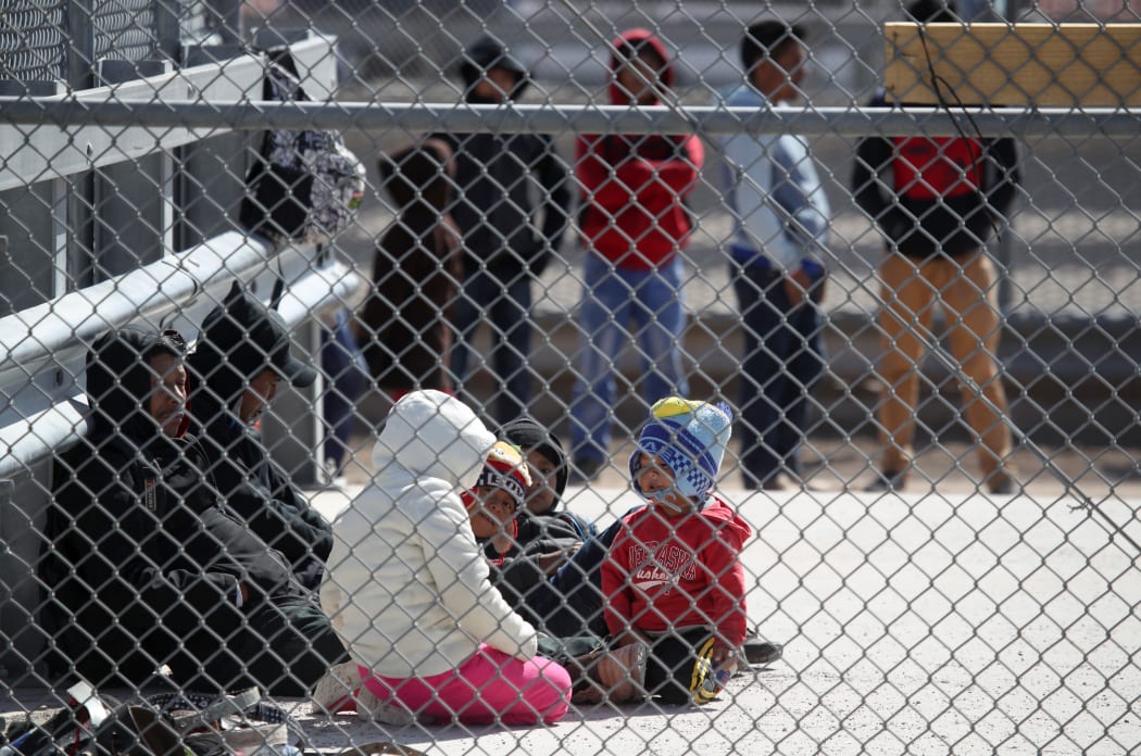 Detained migrants wait to be transported by the US Border Patrol at the border of the United States and Mexico.