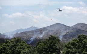 Helicopters douse a fire in Northland.