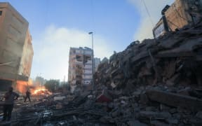 Residents inspect the damage following Israeli airstrikes on the Mreijeh neighbourhood in Beirut's southern suburbs on 4 October, 2024.