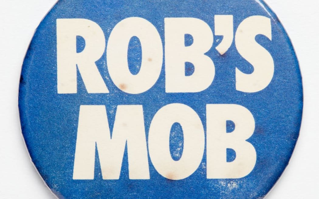 Badges like this were worn by supporters of Prime Minister Robert Muldoon (1975 - 84) who was one of New Zealand's most polarising prime ministers.