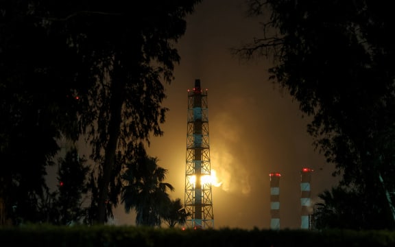 Excess gas is burned at the oil refinery in Israel's northern city of Haifa late on March 19, 2026. Amid growing fears over the economic damage from the Middle East war, US President Donald Trump said there would be no repeat of Israel's attack on Iran's key South Pars gas field, but he warned of a furious US response if Tehran did not halt strikes on Qatar. Iran responded that it would have "zero restraint" if its energy infrastructure was hit again. (Photo by Odd ANDERSEN / AFP) /