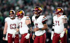PHILADELPHIA, PENNSYLVANIA - JANUARY 26: Jayden Daniels #5 of the Washington Commanders runs off the field after being sacked on a fourth down while playing the Philadelphia Eagles during the fourth quarter in the NFC Championship Game at Lincoln Financial Field on January 26, 2025 in Philadelphia, Pennsylvania.   Emilee Chinn/Getty Images/AFP (Photo by Emilee Chinn / GETTY IMAGES NORTH AMERICA / Getty Images via AFP)