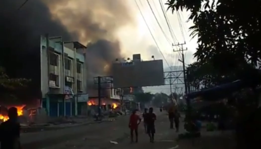 Buildings near the port being torched in Jayapura