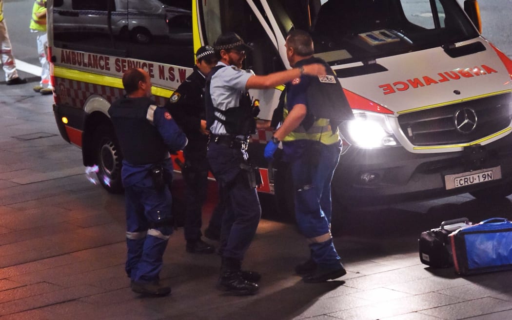 Police put body armour on ambulance personnel during the siege.