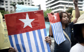 Protesters display the West Papuan pro-independence "Morning Star" flag during a demonstration by mostly university students from Free Papua Organization and the Papua Student Alliance in Jakarta on April 3, 2017. -