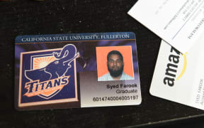 The California State University Fullerton student identification of San Bernardino mass murder suspect Syed Farook sits on a desk inside Farook's home