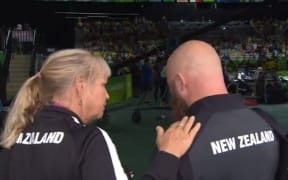 Weightlifter Richie Patterson being consoled after breaking down during a TV interview.