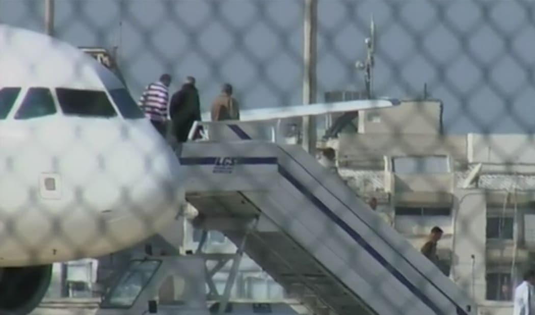 A screenshot from the BBC shows passengers leaving the aircraft in Larnaca.