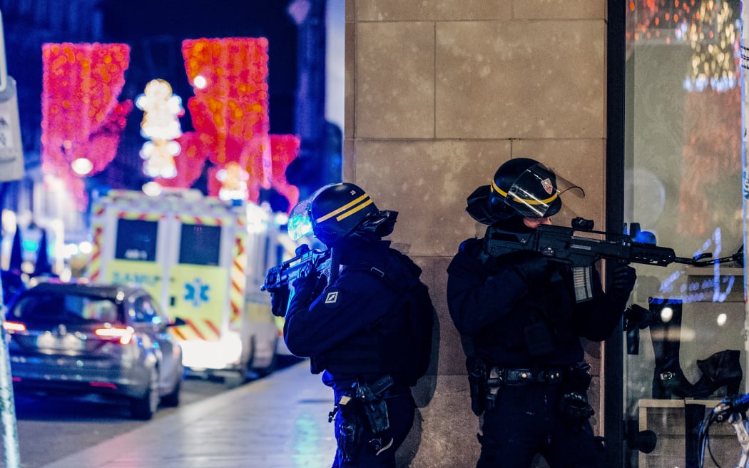 Police officers stand guard near the scene of the shooting in Strasbourg, 11 December 2018. A gunman killed three people before fleeing the scene.
