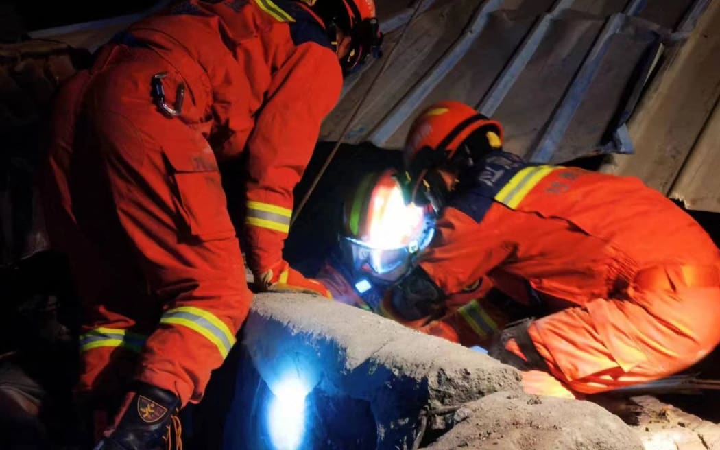 (231219) -- LINXIA, Dec. 19, 2023 (Xinhua) -- Rescuers try to evacuate stranded residents at Kangdiao Village of Jishishan Bao'an, Dongxiang, Salar Autonomous County in Linxia Hui Autonomous Prefecture, northwest China's Gansu Province, Dec. 19, 2023. The 6.2-magnitude earthquake that jolted an ethnic county in northwest China's Gansu Province at midnight Monday has killed 105 people in the province, according to a local press conference held on Tuesday morning. (Photo by Fire and Rescue Department of Gansu/Xinhua) (Photo by Fire and Rescue Department of Ga / XINHUA / Xinhua via AFP)