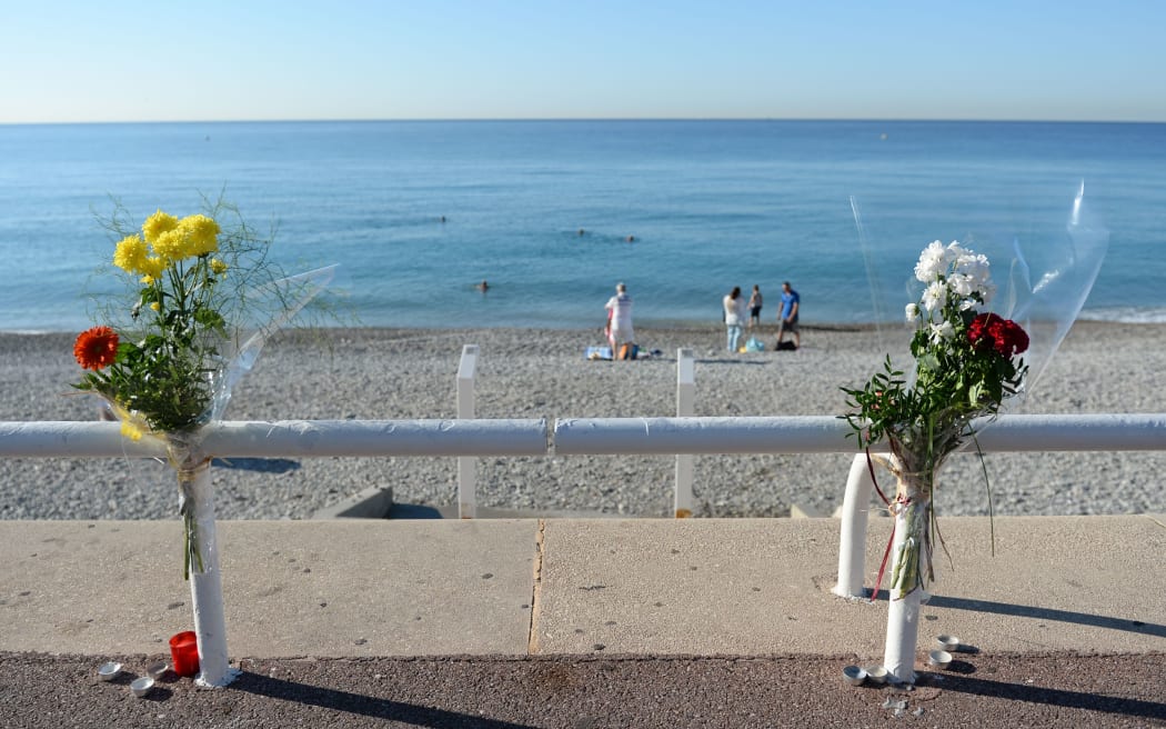 Flowers are tucked to a fence near the spot where someone was killed on Promenade des Anglais in Nice, France, July 17, 2016, when a truck drove into a crowd during Bastille Day celebrations.