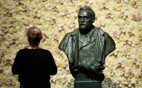 (FILES) In this file photo taken on December 10, 2019 a visitor stands in front of a bust of the Nobel Prize founder, Alfred Nobel prior the Nobel awards ceremony  at the Concert Hall in Stockholm, Sweden.