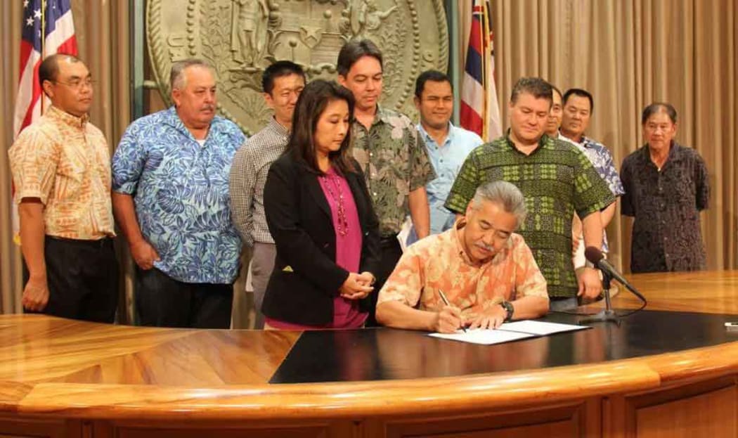 Hawaii Governor David Ige signs the bill into law on how to fund a Honolulu rail shortfall to complete construction.