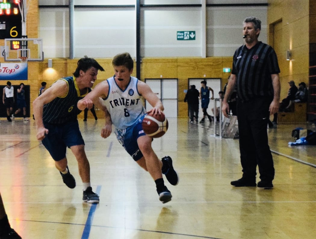 Cy Coldiron (with ball) playing basketball for Trident High during his NZ stay.