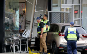 A woman at an Auckland cafe has been left bleeding and with life-threatening injuries after a car crashed into the building in Auckland.