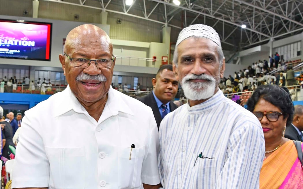 Sitiveni Rabuka, left, with a girmit descendent and Indo-Fijian community leader at the reconciliation church service on 14 May 2023.