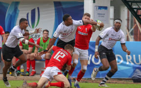 Ilaisa Droasese tests the Welsh defence.