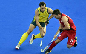 Australia's Tom Craig and Belgium's Arthur de Sloover pictured in action during a hockey game between Australia and Belgium's national team the Red Lions, game 3 in the men's pool B at the Paris 2024 Olympic Games, on Tuesday 30 July 2024 in Paris, France. The Games of the XXXIII Olympiad are taking place in Paris from 26 July to 11 August. The Belgian delegation counts 165 athletes competing in 21 sports. BELGA PHOTO DIRK WAEM (Photo by DIRK WAEM / BELGA MAG / Belga via AFP)